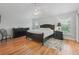 Spacious bedroom with dark wood furniture and hardwood floors at 591 Allenwood Loop, The Villages, FL 32162