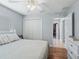 Well-lit bedroom featuring hardwood floors, a comfortable bed, and closet space at 591 Allenwood Loop, The Villages, FL 32162