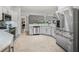 Modern kitchen featuring stainless steel appliances, white cabinets, and an open layout at 591 Allenwood Loop, The Villages, FL 32162