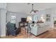 Comfortable living area featuring hardwood floors, a ceiling fan, and plenty of natural light at 591 Allenwood Loop, The Villages, FL 32162