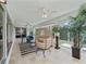 Bright living room with plush seating, stylish rug, and views of the lush outdoor greenery at 591 Allenwood Loop, The Villages, FL 32162