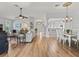Spacious living room showcases hardwood flooring, a ceiling fan, and leads into a bright open kitchen at 591 Allenwood Loop, The Villages, FL 32162
