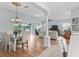 Bright dining and living area with hardwood flooring, and direct access to outdoor screened in porch at 591 Allenwood Loop, The Villages, FL 32162