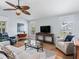 Cozy living area has hardwood floors, natural light and an airy feel from the vaulted ceiling at 591 Allenwood Loop, The Villages, FL 32162