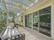 Inviting outdoor patio with comfortable seating under a decorative pergola with views of the lush yard at 591 Allenwood Loop, The Villages, FL 32162