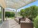 Relaxing outdoor patio area with comfortable seating and a view of the well-maintained garden at 591 Allenwood Loop, The Villages, FL 32162