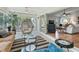 Cozy sunroom with comfortable seating and access to an outdoor screened in porch and the indoor living room at 591 Allenwood Loop, The Villages, FL 32162