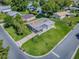 Aerial view of the home with a metal roof, carport, and manicured lawn, surrounded by a peaceful neighborhood at 601 Jason Dr, The Villages, FL 32159