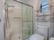 Bathroom featuring a glass enclosed shower, toilet, and shelving unit at 601 Jason Dr, The Villages, FL 32159