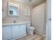 Well-lit bathroom featuring a shower and tub combo behind a curtain, toilet, and vanity at 601 Jason Dr, The Villages, FL 32159