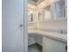 Bathroom vanity with mirrored cabinets and a white sink at 601 Jason Dr, The Villages, FL 32159