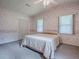 Bedroom featuring floral wallpaper, two windows, a ceiling fan, carpeted floors and a closet at 601 Jason Dr, The Villages, FL 32159