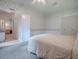 Bedroom with floral wallpaper, carpet, and view to an adjacent vanity and doorway at 601 Jason Dr, The Villages, FL 32159