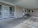 Covered carport featuring a seating area and multiple entry points at 601 Jason Dr, The Villages, FL 32159