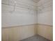 Walk-in closet featuring wire shelving, carpet, and wood trim at 601 Jason Dr, The Villages, FL 32159