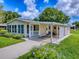 Inviting home with a cozy porch, carport, and sunroom perfect for relaxation at 601 Jason Dr, The Villages, FL 32159
