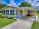 Inviting home with a cozy porch, carport, and sunroom perfect for relaxation at 601 Jason Dr, The Villages, FL 32159