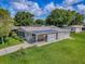 Inviting single-story home featuring a covered carport and a well-maintained lawn with lush landscaping at 601 Jason Dr, The Villages, FL 32159