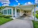 Home exterior showcasing a covered carport, tidy landscaping, and neutral color scheme at 601 Jason Dr, The Villages, FL 32159