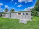 Cozy home featuring a covered patio, well-maintained lawn, and a convenient storage shed at 601 Jason Dr, The Villages, FL 32159