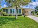 Charming home with a well-manicured lawn, carport, and ample parking space at 601 Jason Dr, The Villages, FL 32159