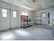 Garage with double doors, workbench, laundry area, and storage at 601 Jason Dr, The Villages, FL 32159