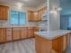 Bright kitchen with wooden cabinets, light countertops, and updated appliances at 601 Jason Dr, The Villages, FL 32159