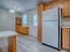 Spacious kitchen featuring wood cabinets and white appliances at 601 Jason Dr, The Villages, FL 32159