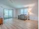 Inviting living room featuring neutral walls, a comfortable sofa, and sliding door at 601 Jason Dr, The Villages, FL 32159