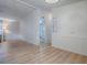 Open-concept living room, showcasing wood-look floors and white walls at 601 Jason Dr, The Villages, FL 32159