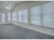 Bright living room with vaulted ceiling, fan, and large windows at 601 Jason Dr, The Villages, FL 32159