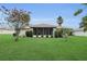 This backyard offers a tranquil oasis with manicured lawn and verdant plantings around the home at 6640 Sw 85Th Pl, Ocala, FL 34476