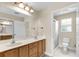 Bathroom featuring double sinks, wood vanity, and a glass-enclosed shower at 6640 Sw 85Th Pl, Ocala, FL 34476