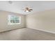 Spacious bedroom featuring laminate flooring, a ceiling fan, and a large window at 6640 Sw 85Th Pl, Ocala, FL 34476