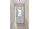 Bright entryway featuring neutral walls, tiled flooring, and a door with decorative glass at 6640 Sw 85Th Pl, Ocala, FL 34476