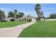 Charming single-story home with a well-manicured lawn, long driveway, and lush palm trees at 6640 Sw 85Th Pl, Ocala, FL 34476