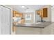 Well-lit kitchen with plenty of cabinet space, a bar area, and all-white appliances at 6640 Sw 85Th Pl, Ocala, FL 34476