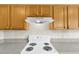 Bright kitchen featuring a white range oven, wood cabinets, and a tiled backsplash at 6640 Sw 85Th Pl, Ocala, FL 34476