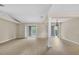 Open living room with neutral walls, light wood flooring, sliding glass doors to the outdoors at 6640 Sw 85Th Pl, Ocala, FL 34476