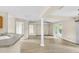 Open-concept living room with wood flooring, breakfast bar, and sliding door access at 6640 Sw 85Th Pl, Ocala, FL 34476