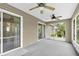 This screened patio features a ceiling fan, sliding glass doors, and outdoor views at 6640 Sw 85Th Pl, Ocala, FL 34476