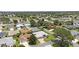 Expansive aerial view of a residential community featuring well-manicured lawns, mature trees, and scenic ponds and golf course at 670 Fayette Ct, The Villages, FL 32162