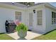 Outdoor patio area featuring a grill, neatly kept grass, and a well lit exterior at 670 Fayette Ct, The Villages, FL 32162