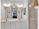 Serene bathroom featuring double sinks, a shower with glass enclosure, and soft lighting at 670 Fayette Ct, The Villages, FL 32162