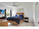 Cozy bedroom featuring tile floors, a ceiling fan, and natural light from the window at 670 Fayette Ct, The Villages, FL 32162