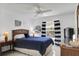 Comfortable bedroom with a ceiling fan, a window with striped curtains, and a wicker headboard at 670 Fayette Ct, The Villages, FL 32162