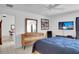 Comfortable bedroom with wood dresser and a modern television, creating a cozy and inviting space at 670 Fayette Ct, The Villages, FL 32162