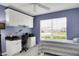 Bedroom featuring a desk, cabinetry, a ceiling fan, and a bright window with natural light at 670 Fayette Ct, The Villages, FL 32162