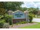 Sign for the Ashland Pool Community surrounded by well maintained shrubs and flowers at 670 Fayette Ct, The Villages, FL 32162