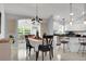 Open-concept dining area adjacent to the kitchen with modern light fixture at 670 Fayette Ct, The Villages, FL 32162